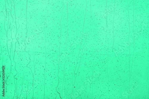 Raindrops on menthol background. Bright and calm shade.