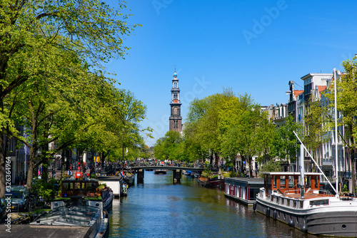 Canvas Print Buildings and boats along the canal in Amsterdam, Netherlands