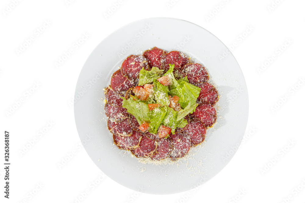 Cold appetizer before alcohol, food marinated roast beef, fried, beef, with tomato, lettuce and grated cheese on plate, white isolated background view from above Cold appetizer before alcohol, food marinated roast beef, fried, beef, with tomato, lettuce and grated cheese on plate, white isolated background view from above