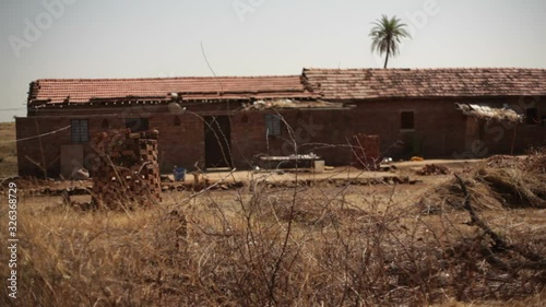 Poor village house in drought area India, long shot, shallow DOF