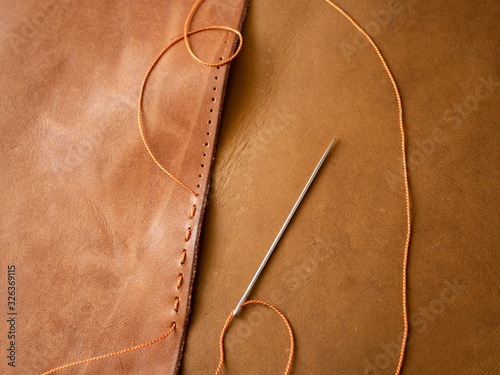 Genuine Leather. Sewing a purse. Leather work. Tools for sewing bags, wallets, clutches. Stitching. Manual sewing of the product. The manufacture of leather products. 