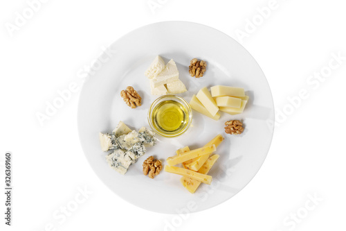 Snack to wine, sweet, a set of cheeses, honey,Walnut, aperitif before alcohol, food on plate, white isolated background view from above. For the menu, restaurant, bar, cafe