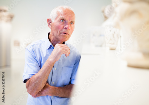 Wallpaper Mural Mature man visiting sculptures exhibition Torontodigital.ca