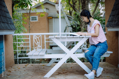 Young asian girl sitting on...