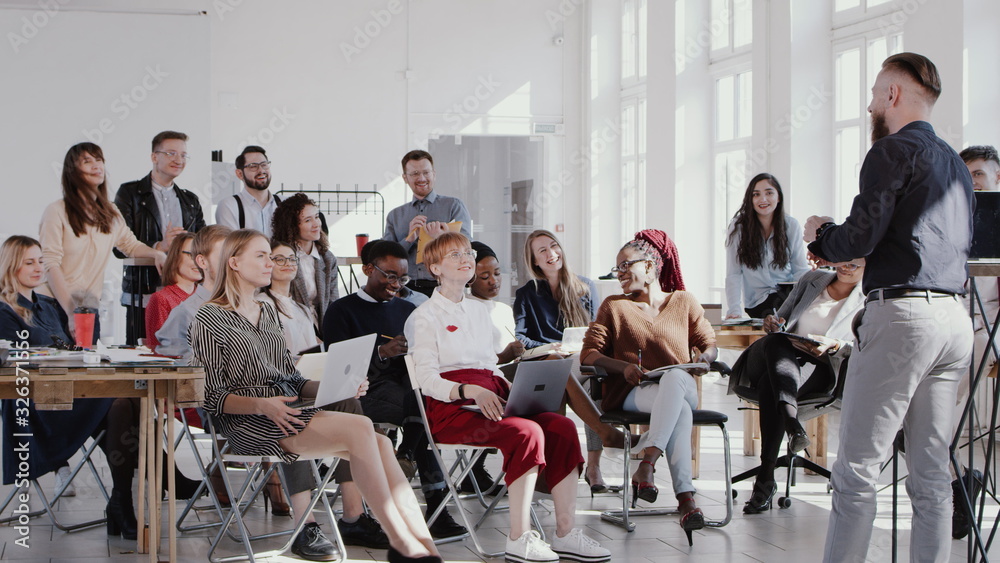 RED EPIC Happy middle aged male finance expert motivating workers at modern healthy workplace office seminar slow motion RED EPIC Happy middle aged male finance expert motivating workers at modern healthy workplace office seminar slow motion