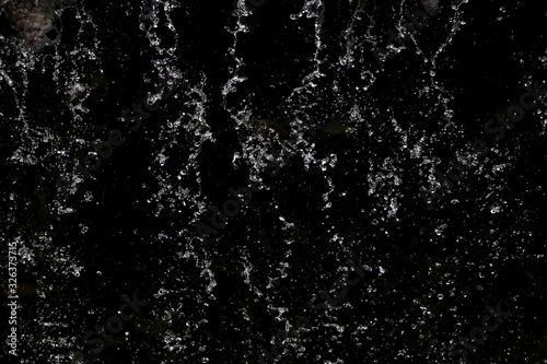 Abstract black background wallpaper texture. Closeup water rain drop splashing.