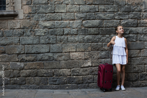 girl in white with travelling bag