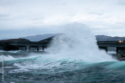 huge wave crashing at bridge on the atlantic ocean road