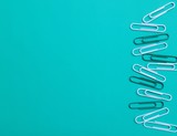 cute green background of paper clips on paper