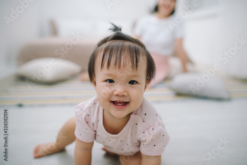 portrait of asian mother and baby relaxing in the room