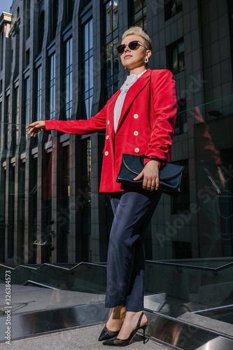 Business woman near glass railing on the street