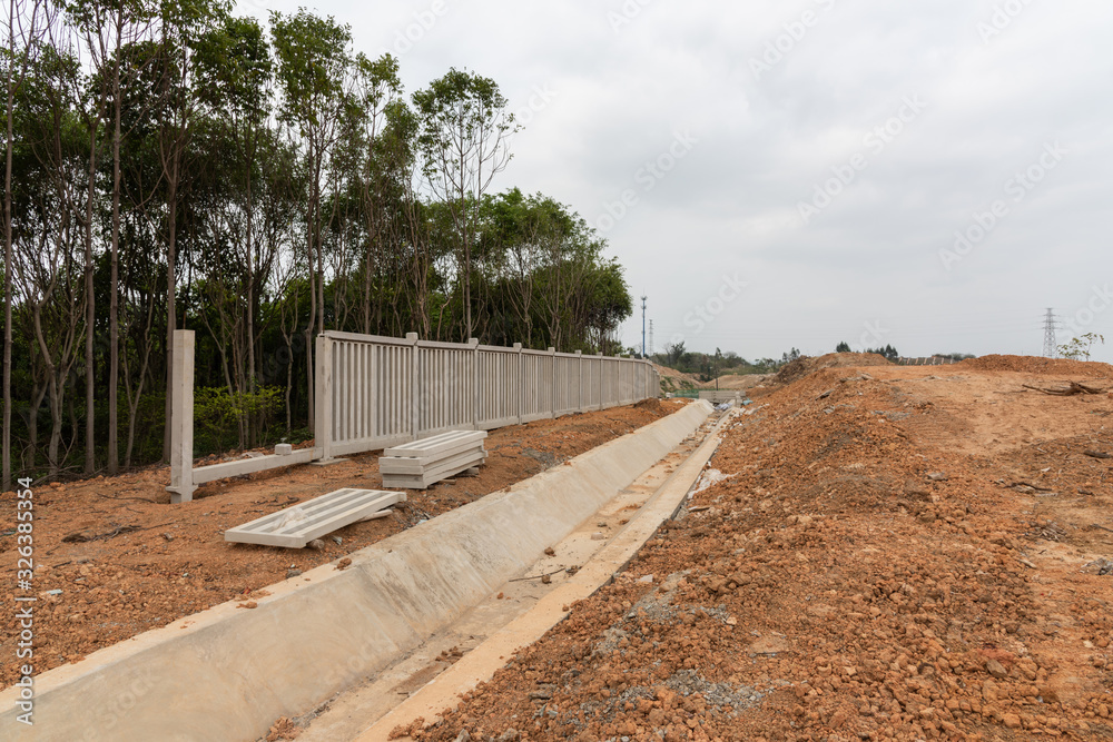 Unfinished road concrete drainage ditch