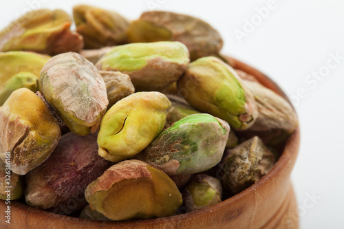 Pistachio nuts. Many pistachios on white. Selective focus.