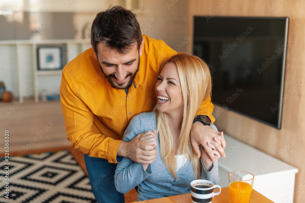 Couple relax at home with cup of coffee