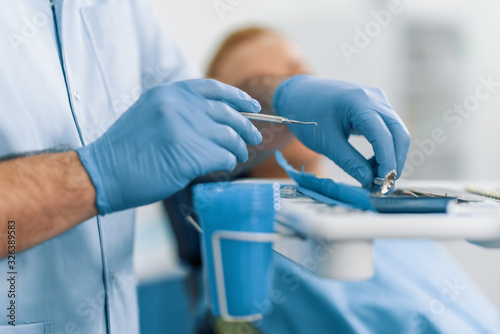 Stomatology instruments in dentist s hands close up