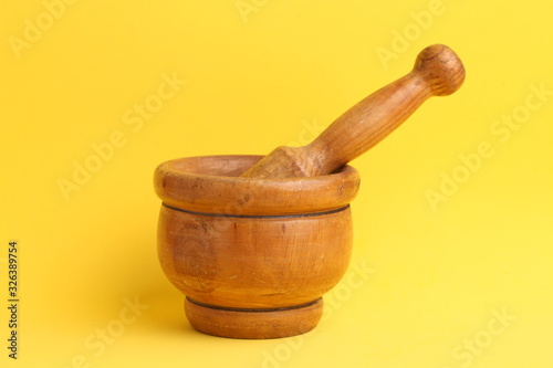 cooking wooden mortar in color background