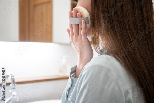 洗面化粧室でメイクをする若い女性 photo