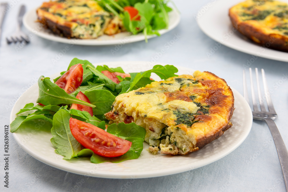 Frittata made of eggs, bacon, cheese and spinach Frittata made of eggs, bacon, cheese and spinach