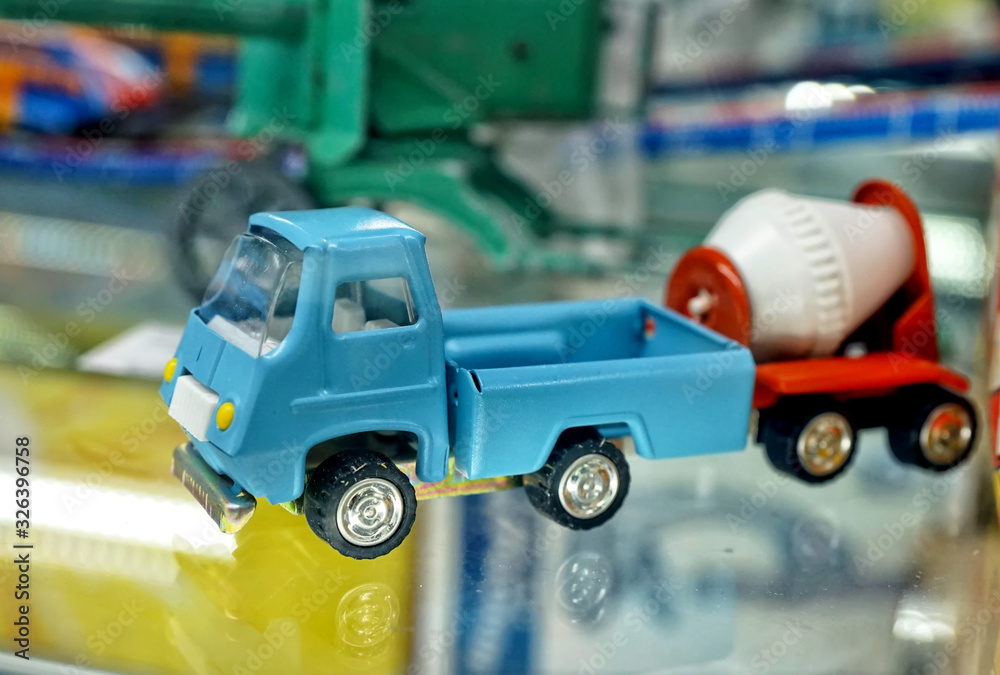Metal, truck, concrete, mixer, Showcase with old toys in a retro toy store. Metal, truck, concrete, mixer, Showcase with old toys in a retro toy store.