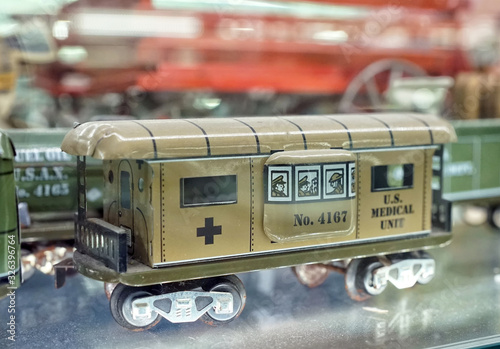 Metal ambulance car. Showcase with old toys in a retro toy store.