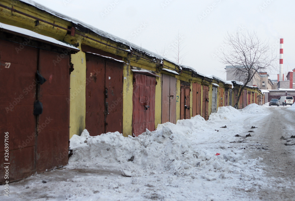 Old garages for cars. Industrial area of the city, winter season. Old garages for cars. Industrial area of the city, winter season.