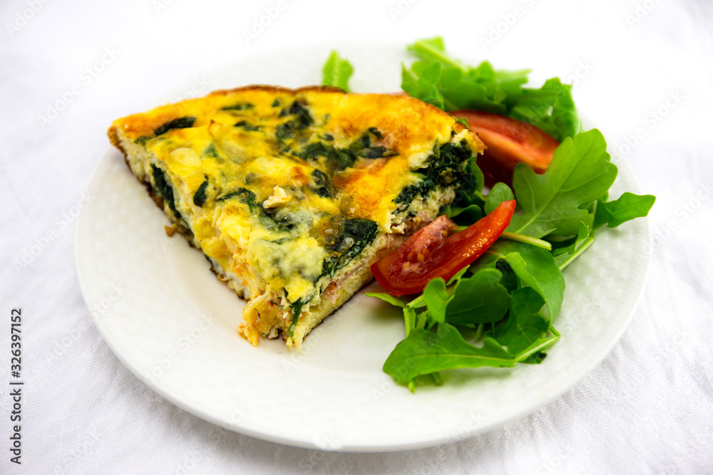 Frittata made of eggs, bacon, cheese and spinach