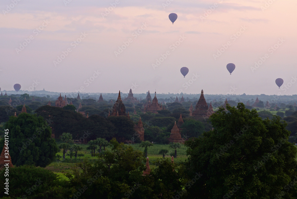 Air ballons flying over Bagan temples and pagodas in early morning before sunrise, Burma Myanmar