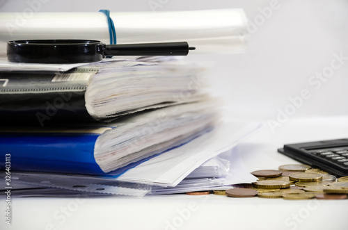 Business concept. Various documents, coins and part of the calculator. White background.