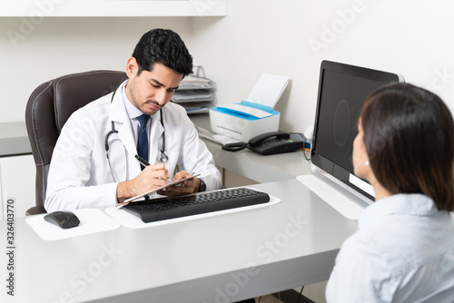 Woman Consulting Neurologist In Hospital