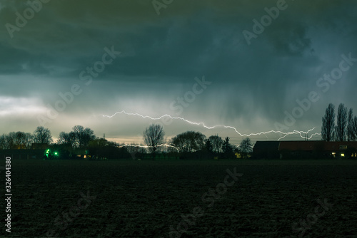 Scenic view of lightning bolts traveling through the sky, close above the horizon