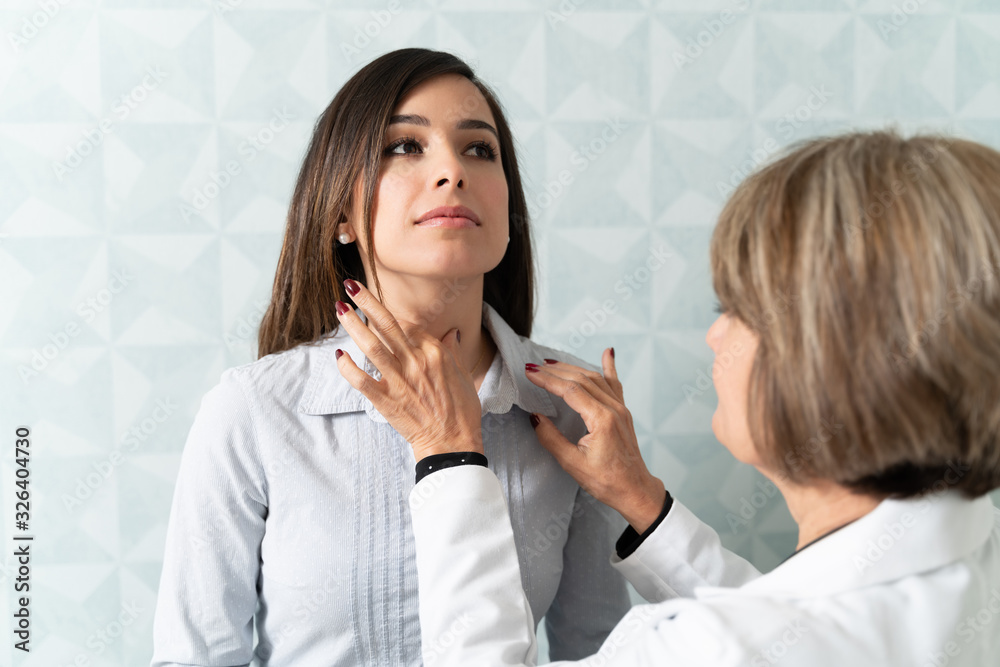 Endocrinologist Examining Patient In Clinic Endocrinologist Examining Patient In Clinic