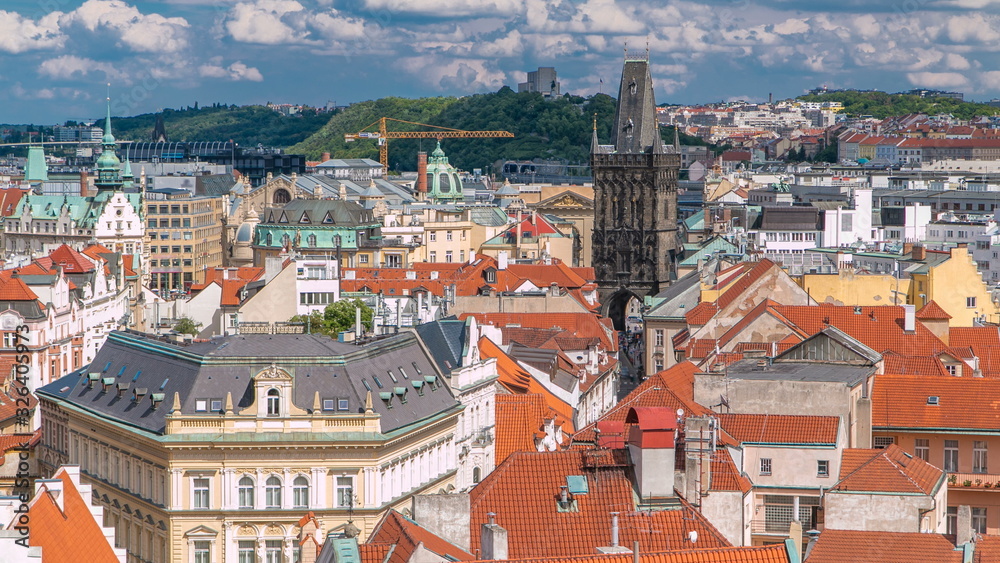 Aerial view of the traditional red roofs of the city of Prague, Czech Republic with the Powder tower and Vitkov Hill in the distance timelapse.