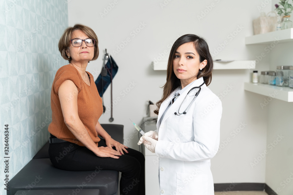 Fototapeta premium Elderly Woman Consulting Doctor In Clinic