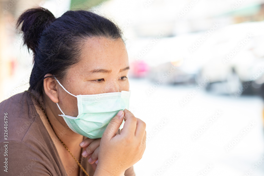 Asian female tourist with hygienic mask to protect PM 2.5 dust and coronavirus or covid-19 virus Asian female tourist with hygienic mask to protect PM 2.5 dust and coronavirus or covid-19 virus