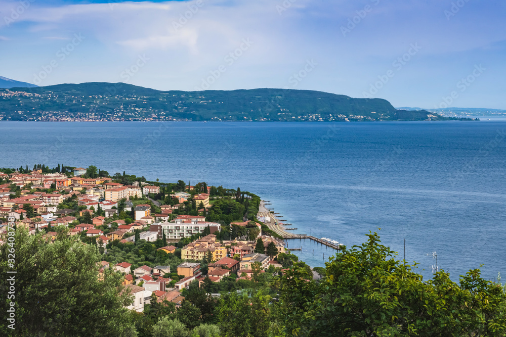 Panoramic view of the city on the shore of lake Garda on an overcast day.