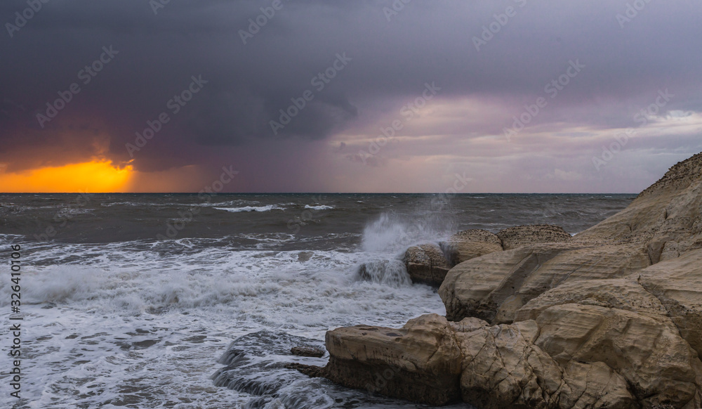 Obraz premium Stormy weather in the evening at sunset on the Mediterranean coast near Rosh HaNikra in Israel