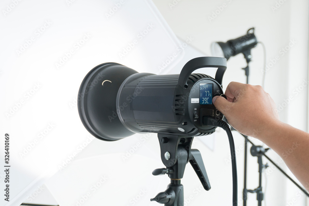 Photographer setting light before take photo in studio Photographer setting light before take photo in studio