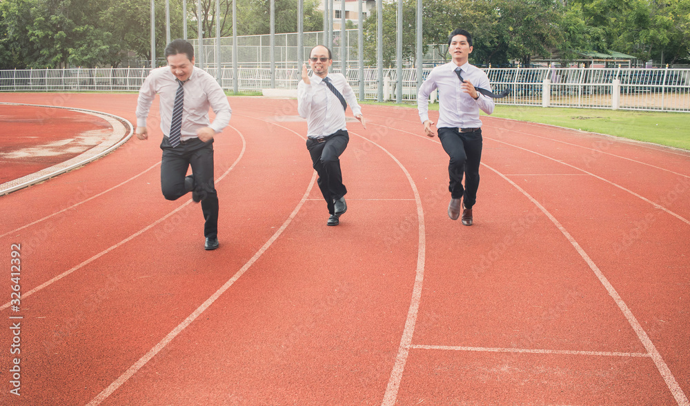 Fototapeta premium Successful young businessman winning the race. Businessman crossing the finish line. Concept of successful businessman in a finishing line.
