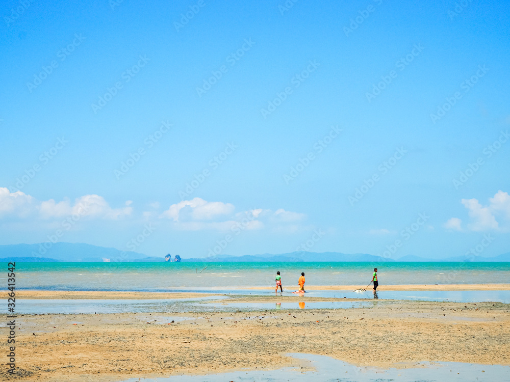 Children are playing in the sea on blue sky day , Koh yao , Thailand