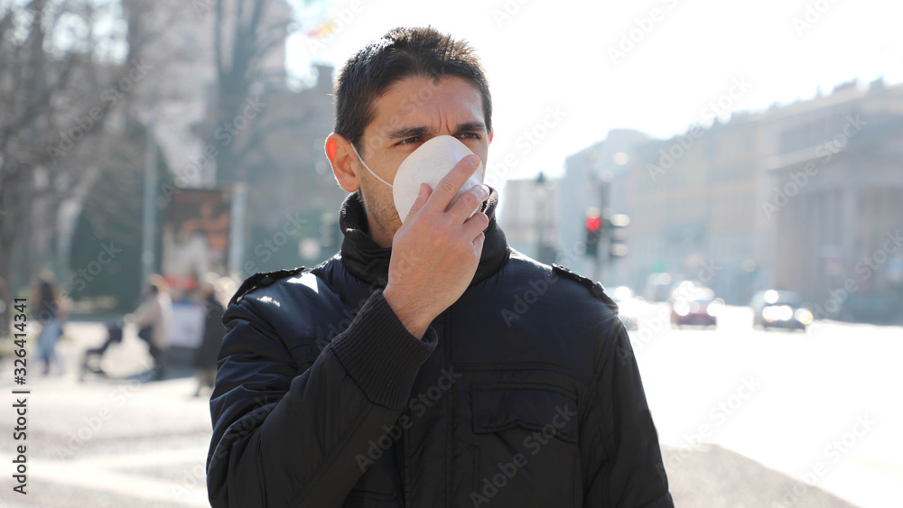 COVID-19 Pandemic Coronavirus Man in city street wearing face mask protective for spreading of Coronavirus Disease 2019. Portrait of man with face mask against SARS-CoV-2. COVID-19 Pandemic Coronavirus Man in city street wearing face mask protective for spreading of Coronavirus Disease 2019. Portrait of man with face mask against SARS-CoV-2.