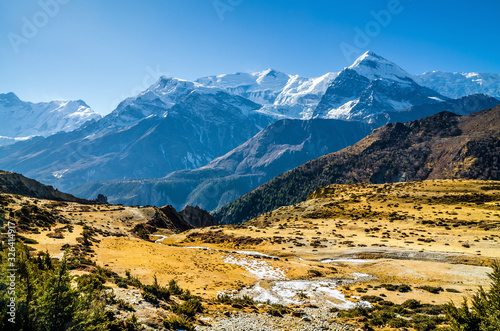 Kone Khola valley with Mt. Gangapurna on the horizon. Trekking route from Manang to Ledar village in autumn sunny day. Annapurna circuit trek  Nepal.
