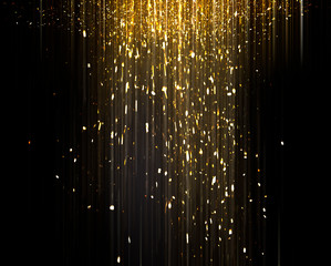 Gold sparkling star dust. Gold sparkles on a black background. shiny background. Gold glittering dust.