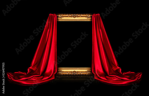 The wooden frame for the picture is covered with a silk red cloth isolated on a black background. Antique golden frame.
