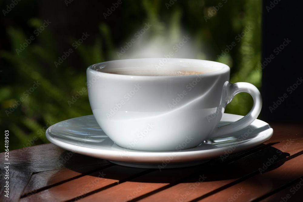 Morning cup of coffee and nature on green background . Morning cup of coffee and nature on green background .