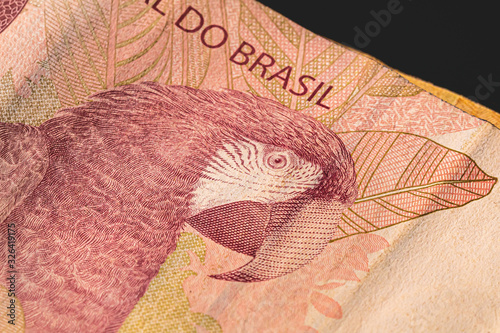 Brazilian currency. 10 reais banknote on a table, black background. photo