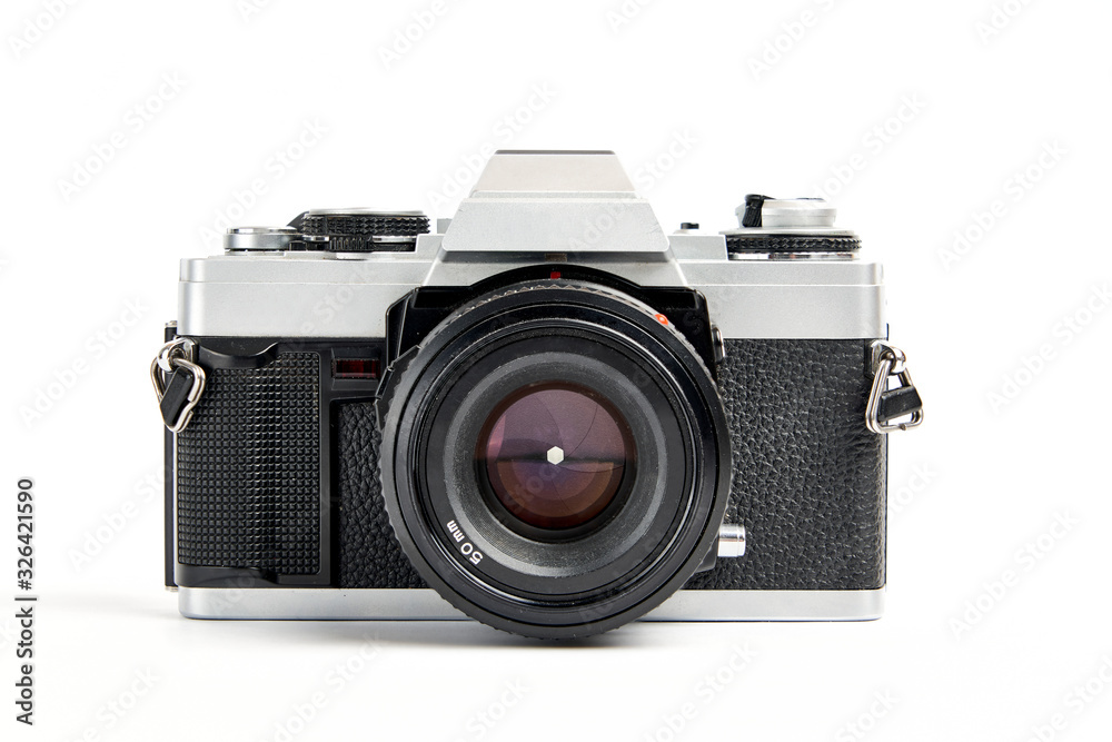 front view of a Classic analog 35 mm camera vintage and analog film rolls on white background