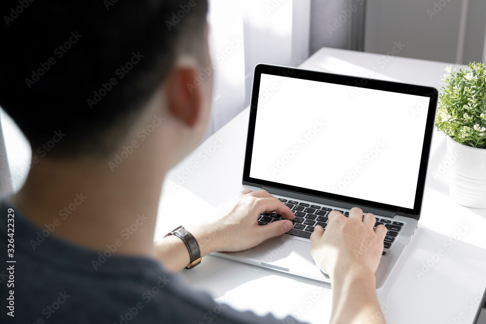 Mockup image of a man working at the laptop