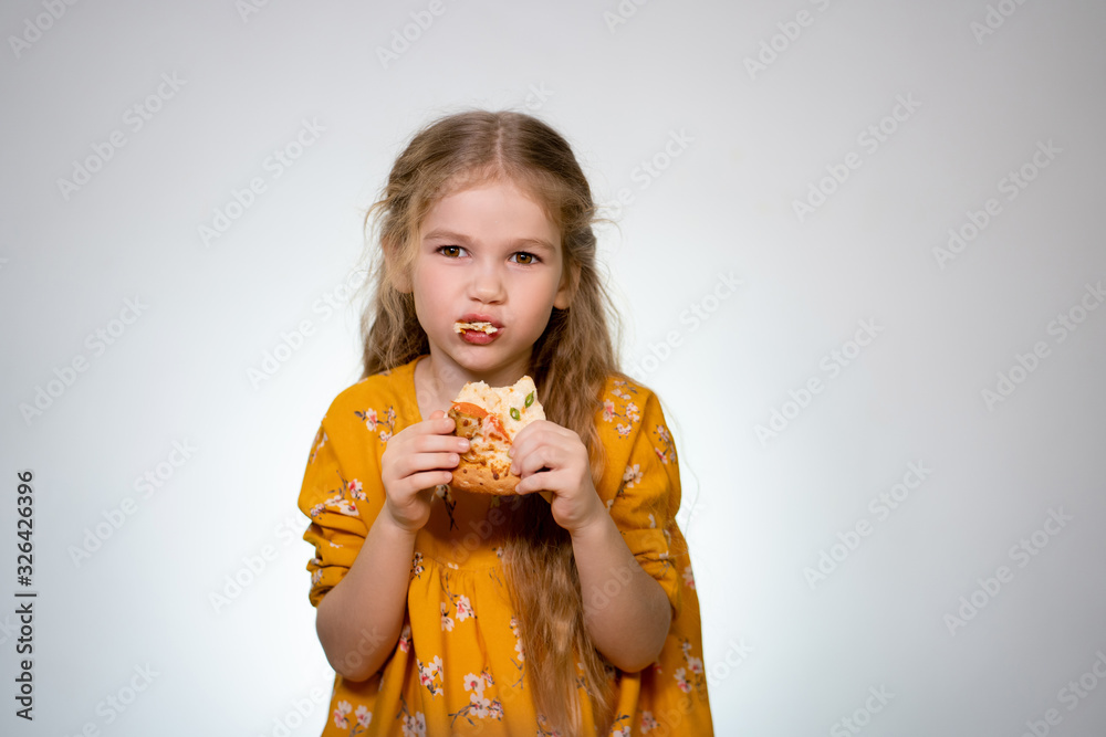 The little girl eating the pizza and laughing.