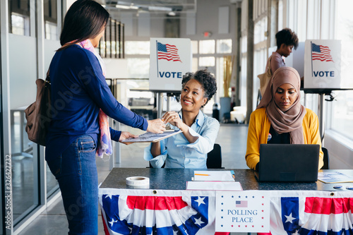 Volunteer helping citizen at polling place