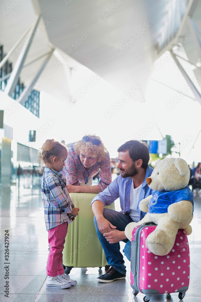 Happy family on a holiday arriving at the airport